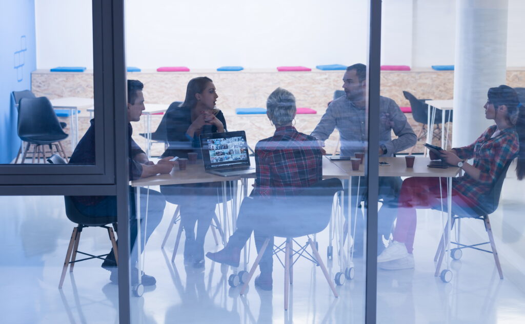 Business team meeting in modern office interior discussing SEC crowdfunding