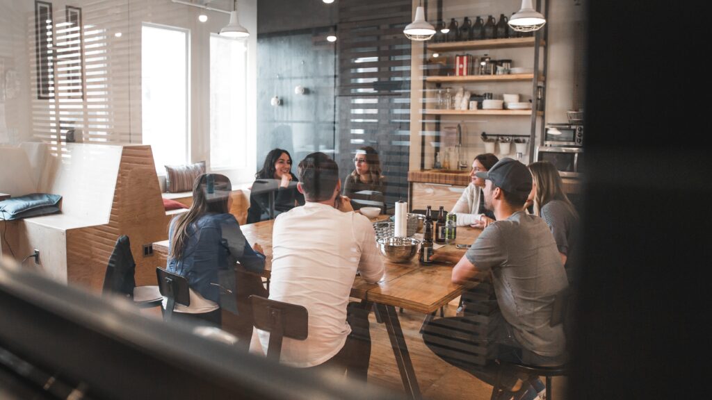 A nonprofit team discussing their upcoming nonprofit annual audit at a large table