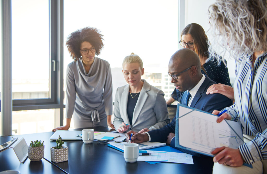 A focused team of accounting professional at a CPA audit firm reviewing documents