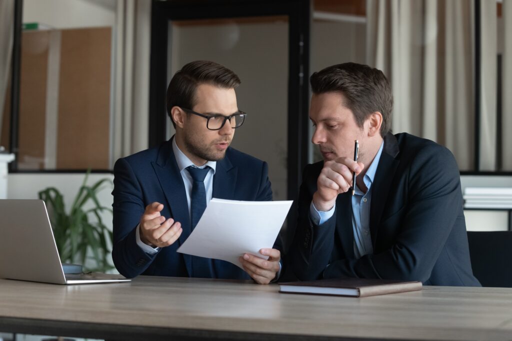 Two male accountants reviewing updates to the pcaob auditing standards