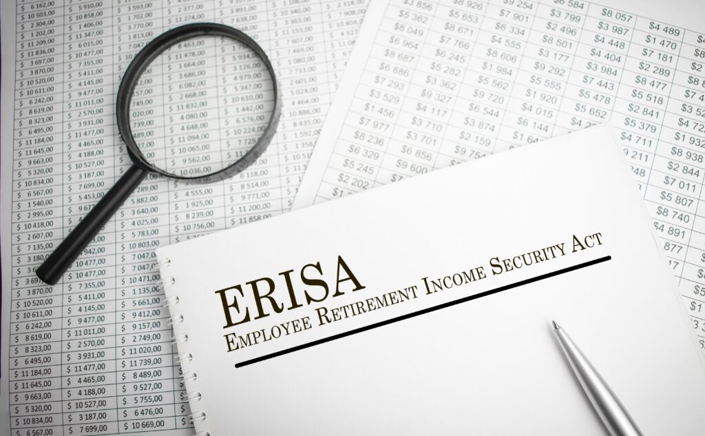 A document explaining what ERISA is laying on top of financial documents for an ERISA audit