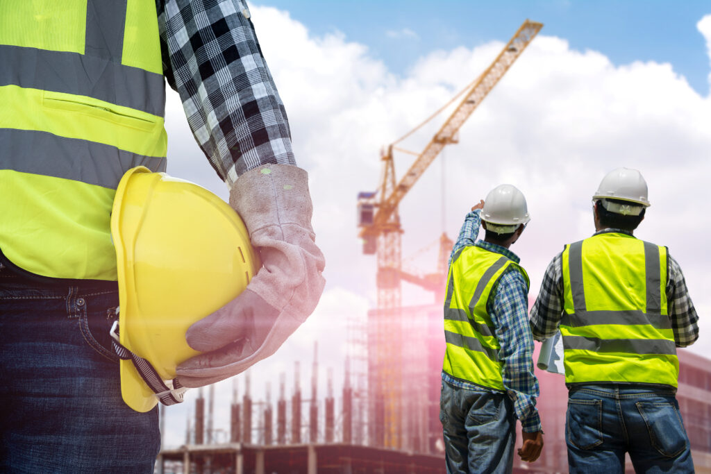 Contractor and engineer discussing construction accounting while on construction site