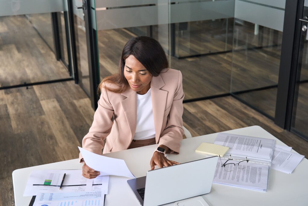 A certified public accountant reviewing documents during an onsite visit to a client