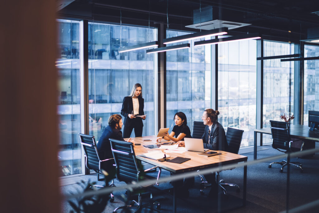 A franchise team meeting in an office conference room to prepare for their financial statement audit