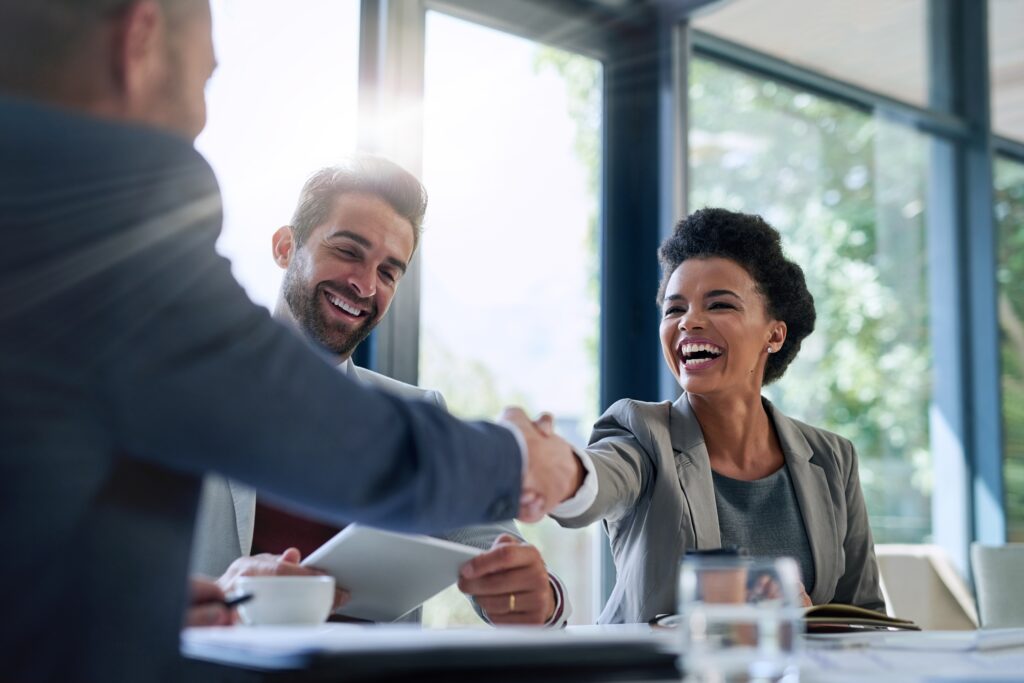 A woman from an organization shaking hands with their CPA who does 401k plan audits