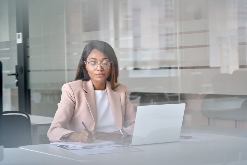 A female CPA at a desk looking at audited financials of a company