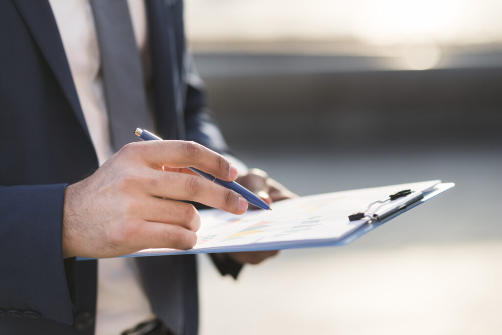 Accountant reviewing Form 5500 audit requirements listed on a clipboard