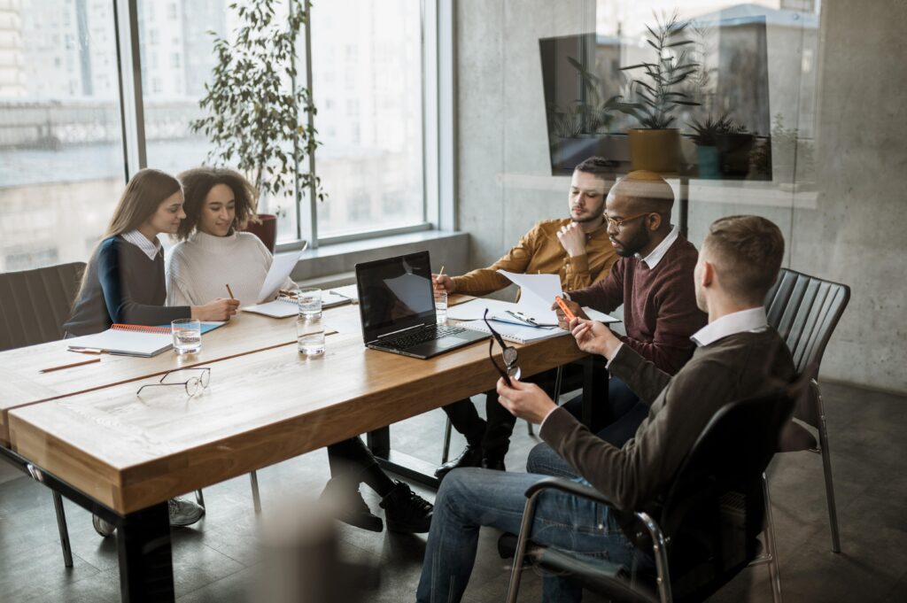 A group of employees at an organization meeting to discuss future 403b audits