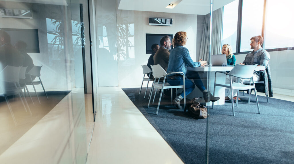 A group of employees at a company discussing preparing for the 401 k audit of their benefit plan