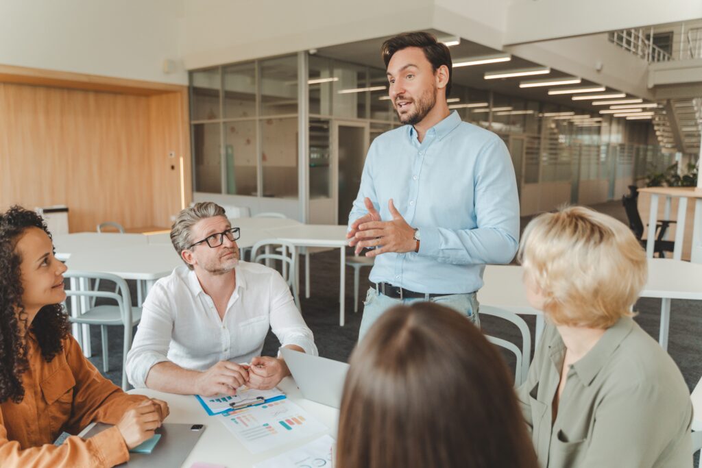 A team at a workplace discussing the upcoming AICPA audit and how it will affect business operations