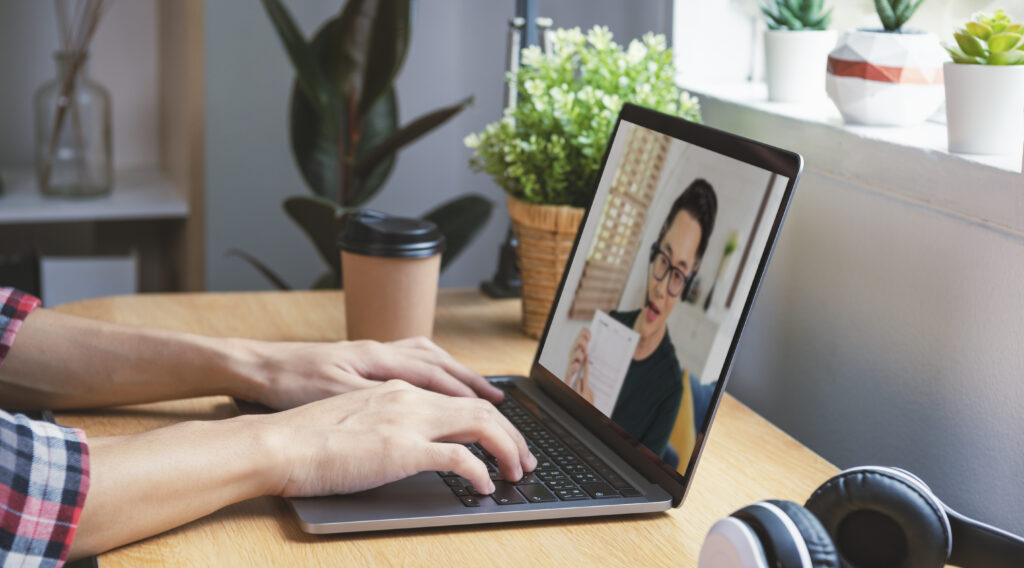 A man talking on a remote audit call with an accountant from one of the top accounting firms