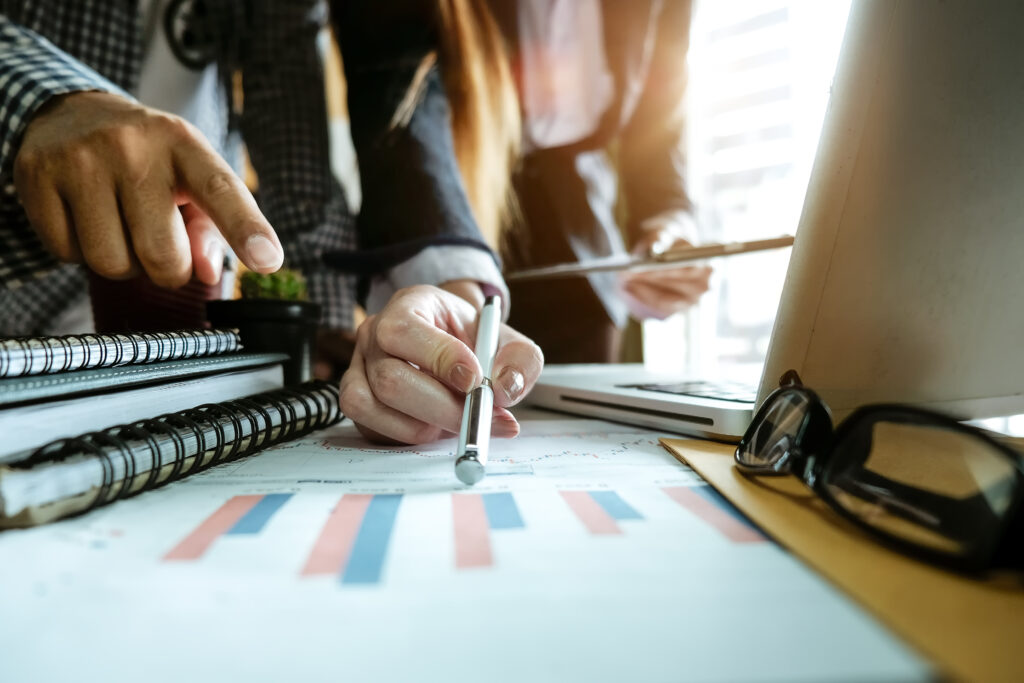 A close up of a woman' hand pointing at information on audited financial statements