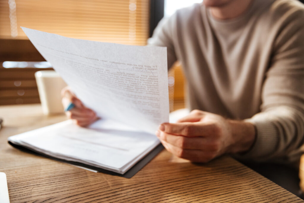 A business owner reading documents to understand private audits