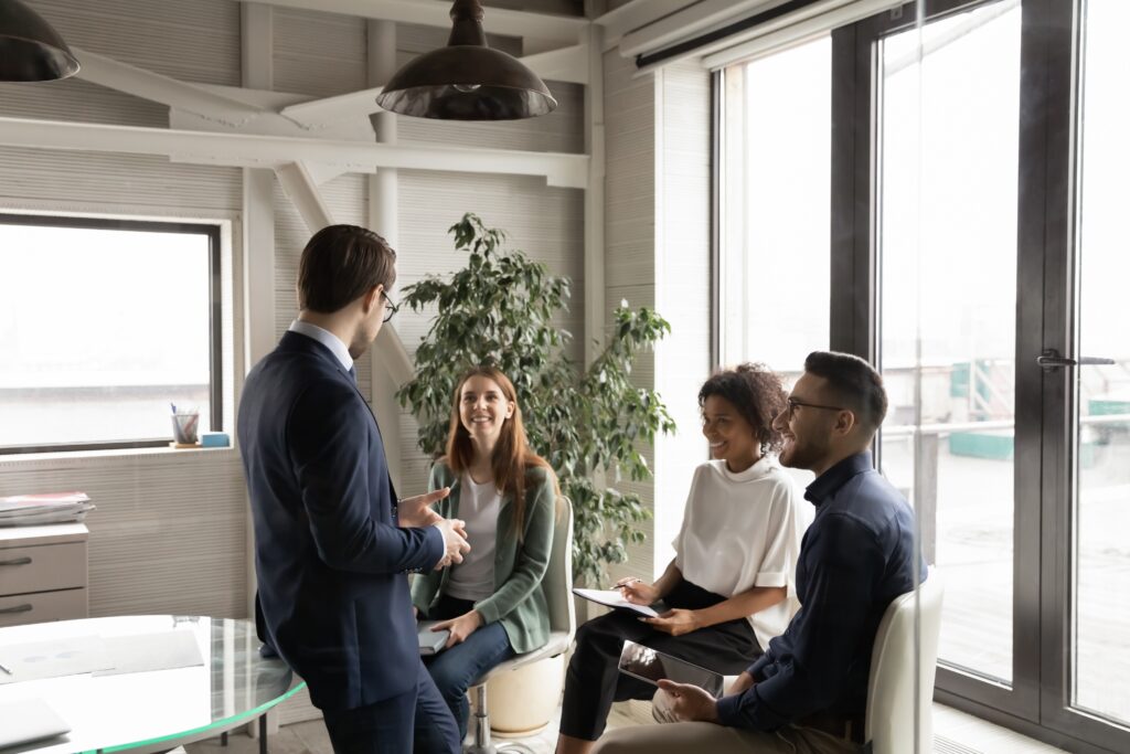 A group of employees sitting down in a meeting to discuss future financial statement audits for their company