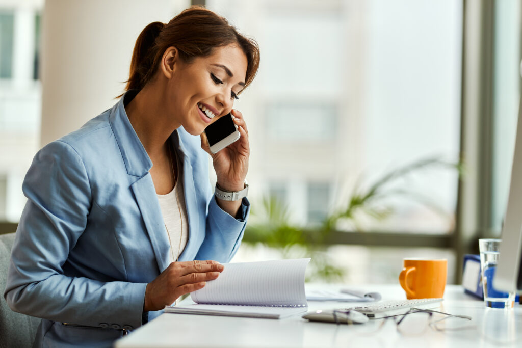 A woman on the phone with her auditor at one of the top accounting firms asking questions about her audit