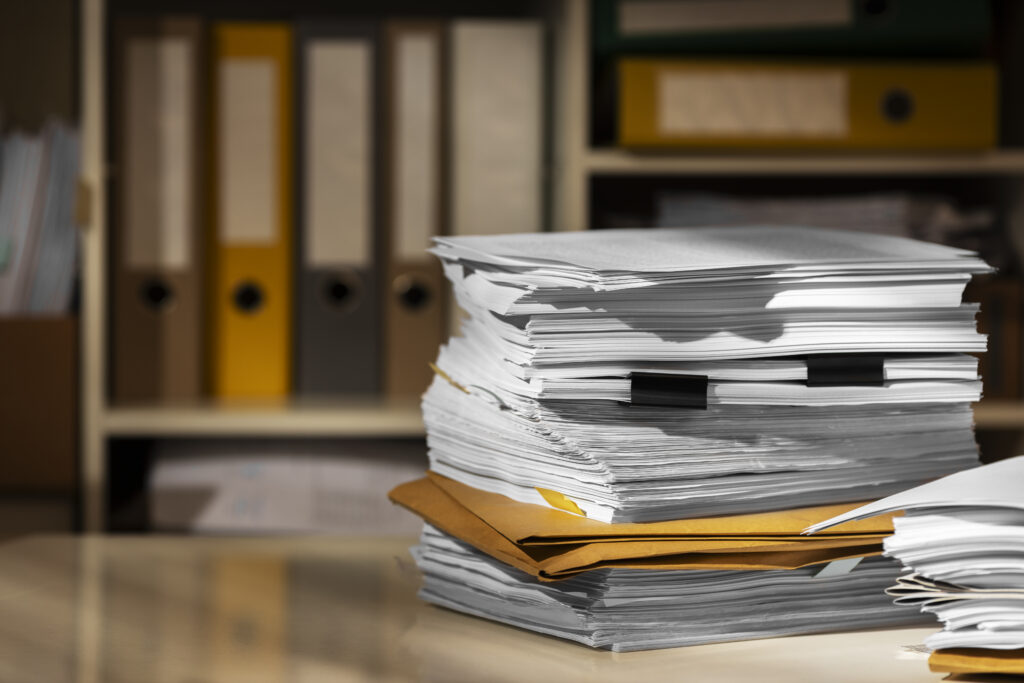 A pile of documents and files gathered for reviewed financial statements