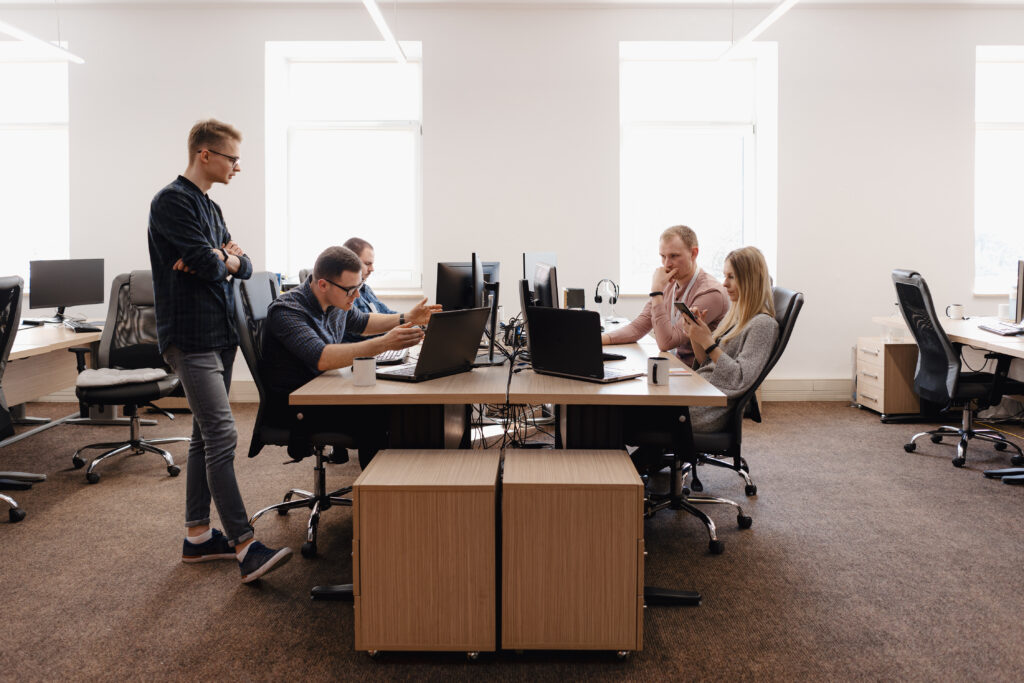 A group of professionals discussing SEC 17a4 compliance at a desk.