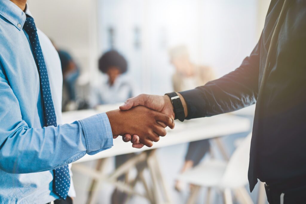 Professional handshake symbolizing trusted accounting and outsourcing services, fostering compliance and client confidence.