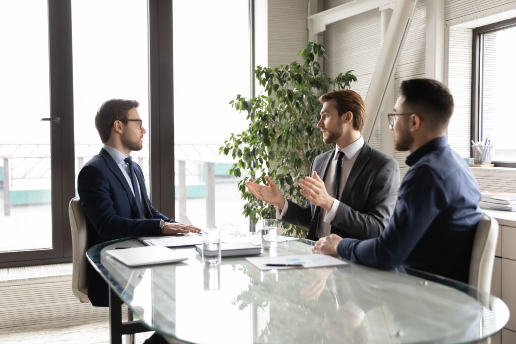 Two business professionals discussing audit and review engagements and their key differences for businesses.