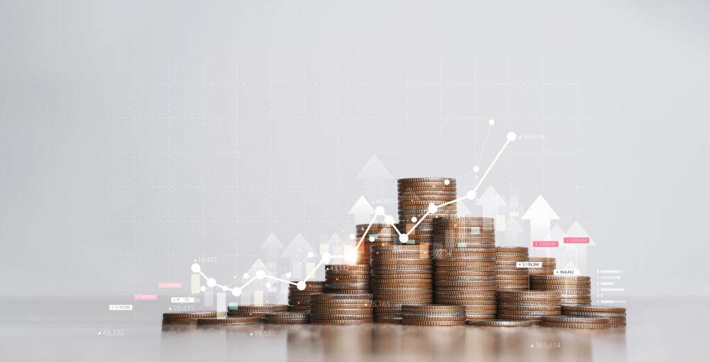 A financial growth chart with stacked coins illustrating the cost of audited financial statements for businesses and organizations.