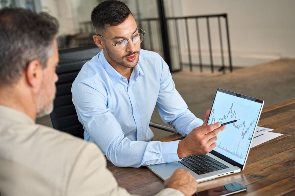 A business professional explaining compilation, review, and audit engagements to a client for financial planning.