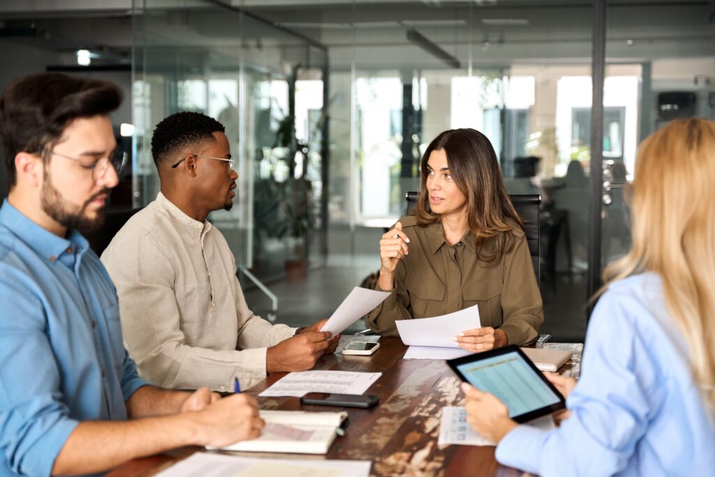 A business team reviewing specific details of compilation, review, and audit engagements for financial compliance.