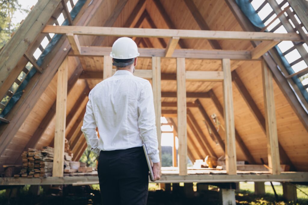 Foreman analyzing financial data on a laptop at a construction site, emphasizing the need for precise contractor accounting.