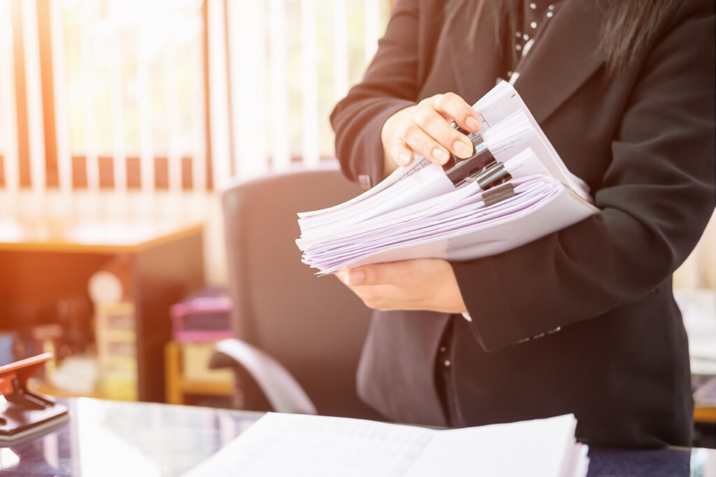 Accountant holding a folder, focusing on franchise requirements as specified in the FDD franchise document.