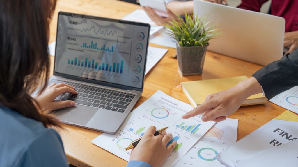 Team reviewing charts and data on a laptop, representing comprehensive financial statement preparation services for accurate reporting.