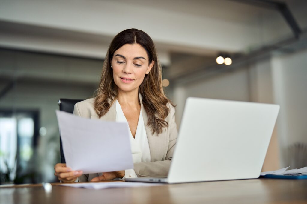 Business professional reviewing financial documents as part of the month-end close process to ensure accurate reporting.