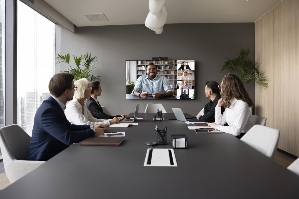 Professionals in a conference room reviewing remote auditor workflows for CPA firm financial audits.