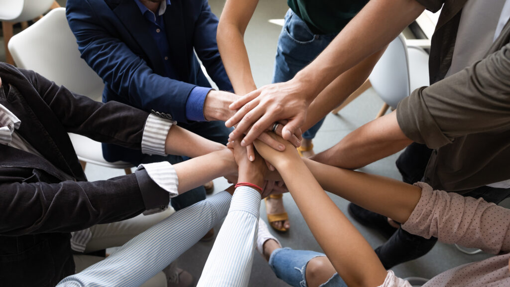 Hands joined together in teamwork, a focus of nonprofit organizations that rely on the expertise of non profit audit firms.