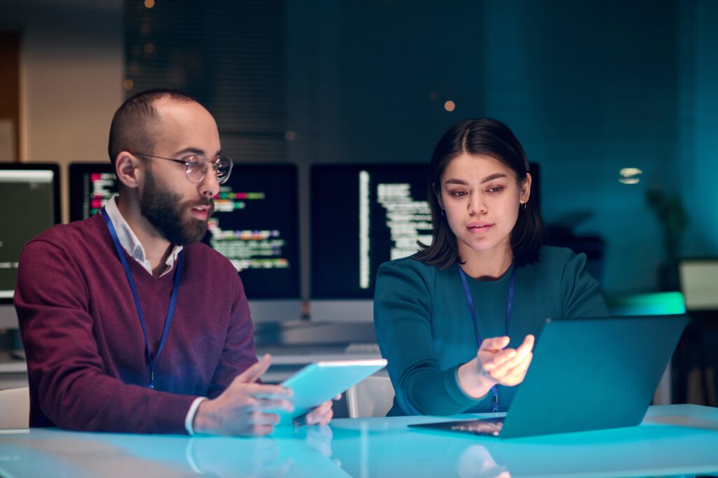 IT specialists review policies in a secure facility to ensure compliance with new SEC cybersecurity regulations