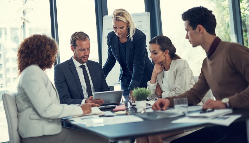 Franchise cpa guidance shown as a business team meets to review financial documents and reports together.