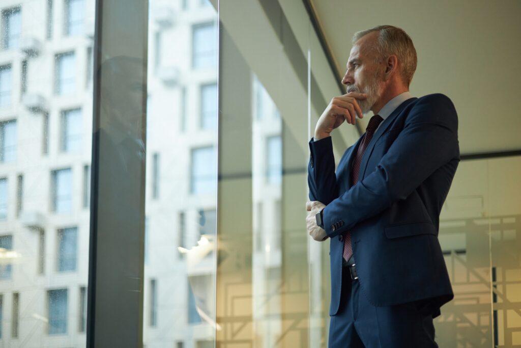 Professional pausing by a window and thinking thoughtfully about the SEC custody rule audit requirement.