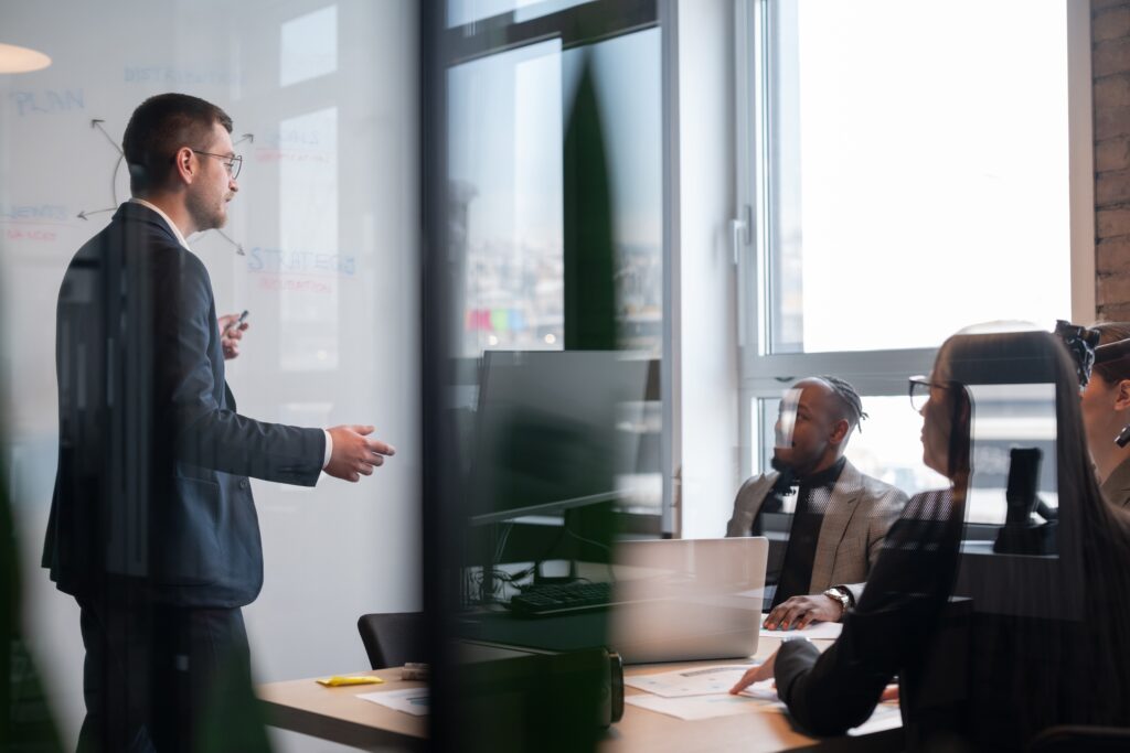 SEC custody rule audit requirement discussion with a presenter and team in a conference room.