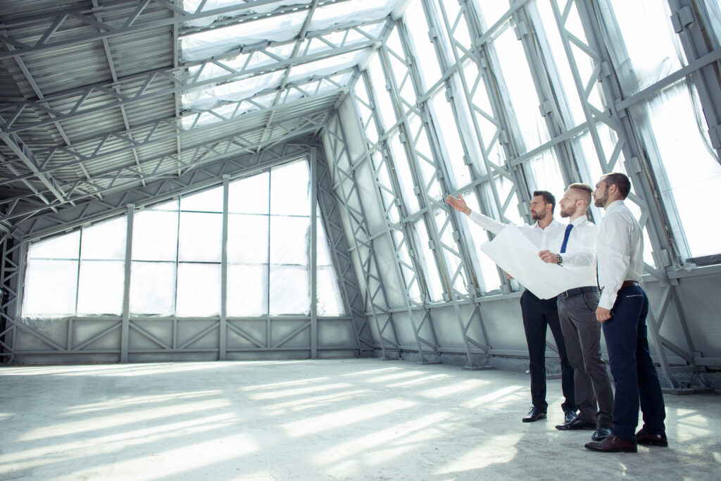 Cyber security and real estate planning with two professionals reviewing a property outside a home