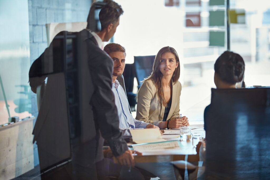 Private equity audits meeting with professionals listening across a conference table.