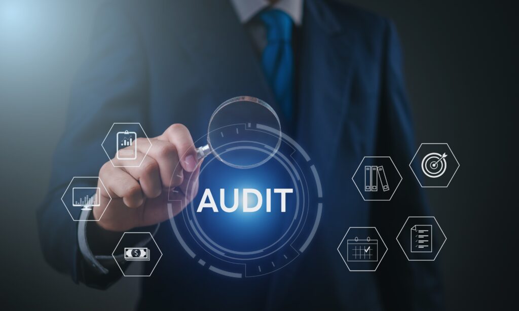 Compilation, review and audit engagements concept with a professional selecting a digital audit dashboard.