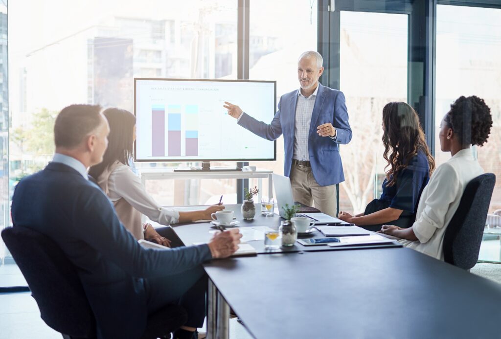 Team attends a chart presentation in a boardroom for Reg SP privacy notice planning