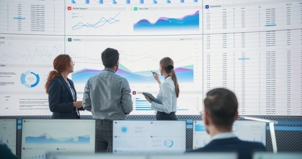 Reg SP privacy notice compliance planning as a team reviews charts, reports, and data screens.