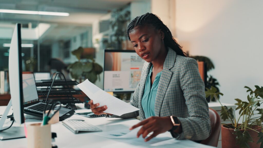 SEC Rule 17a4 requirements paperwork reviewed by a professional at an office desk.