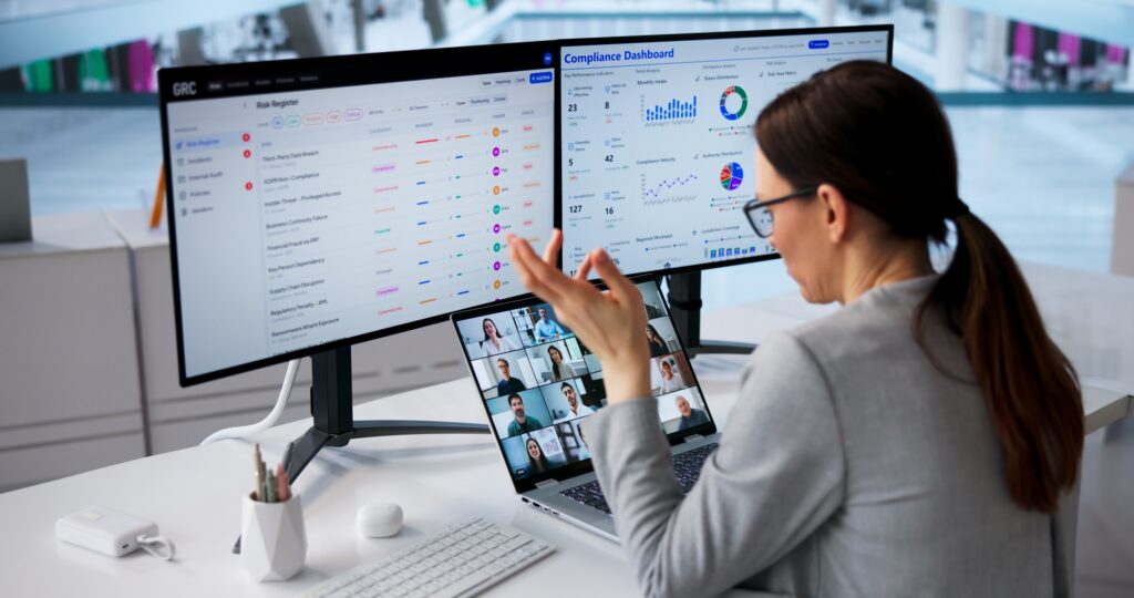 Virtual audit connects a professional with remote colleagues while reviewing compliance dashboards.