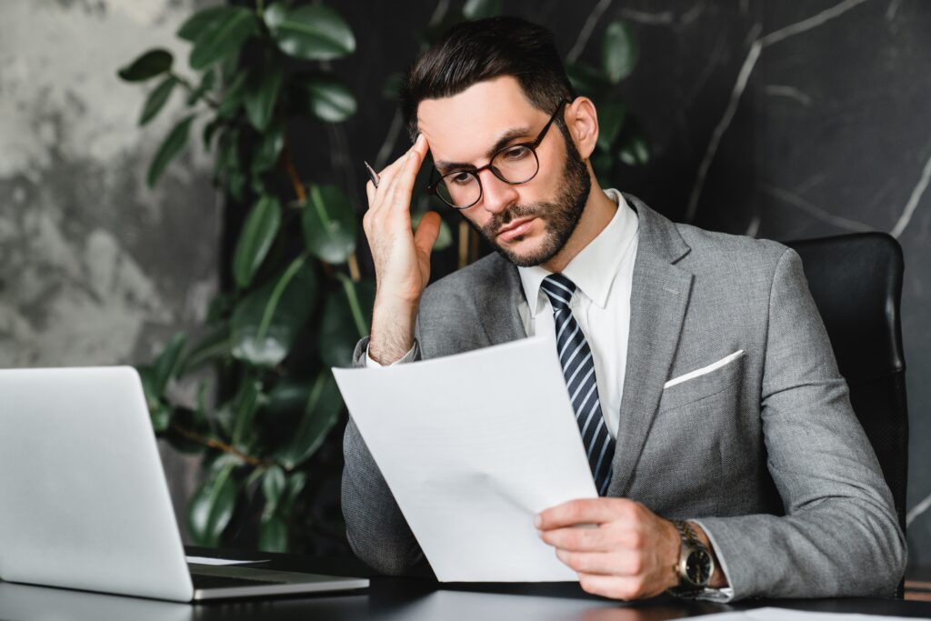 Professional reviewing documents in an office while considering gaps in SOX audit controls.