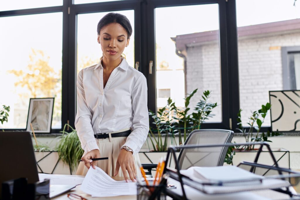 Uniform guidance audit preparation with a professional reviewing documents in a bright office.